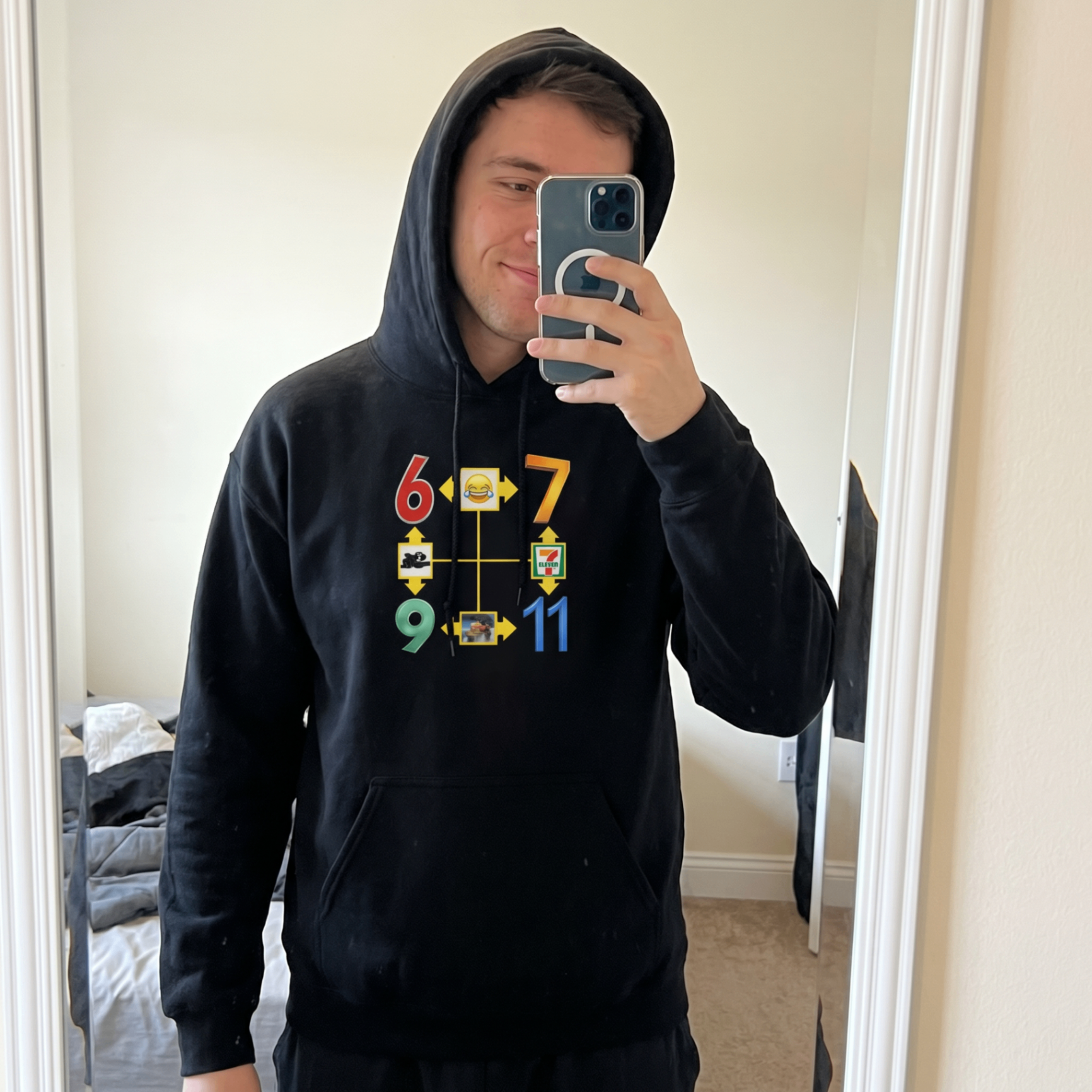 Customer mirror selfie wearing a black hoodie from The Funny Shirt Store.