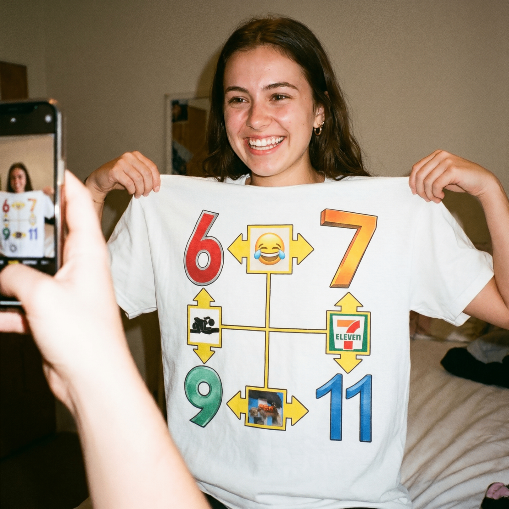 Customer showing off a white graphic tee in a bedroom photo.